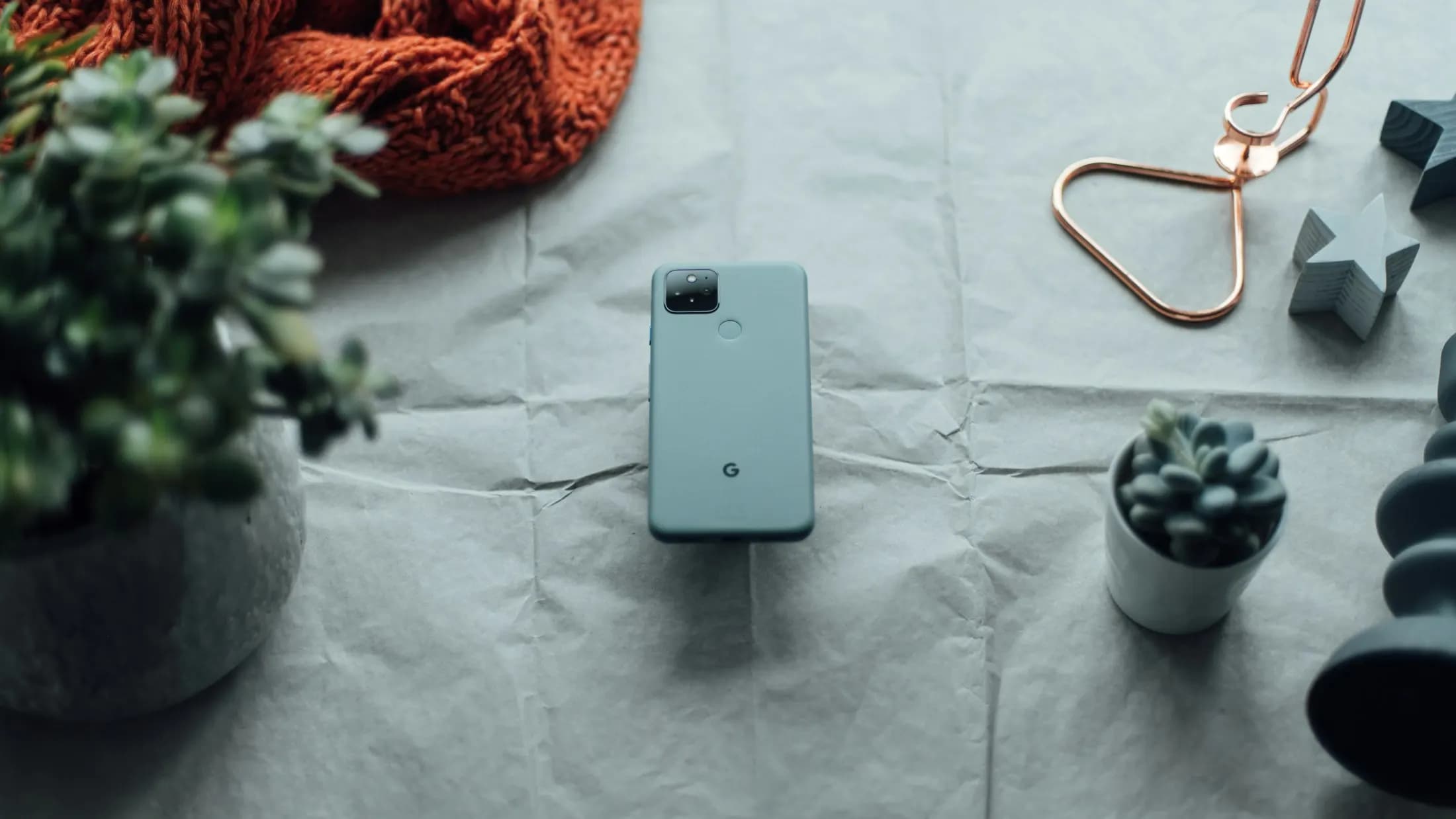 A modern smartphone and accessories arranged on a neutral surface [seed]