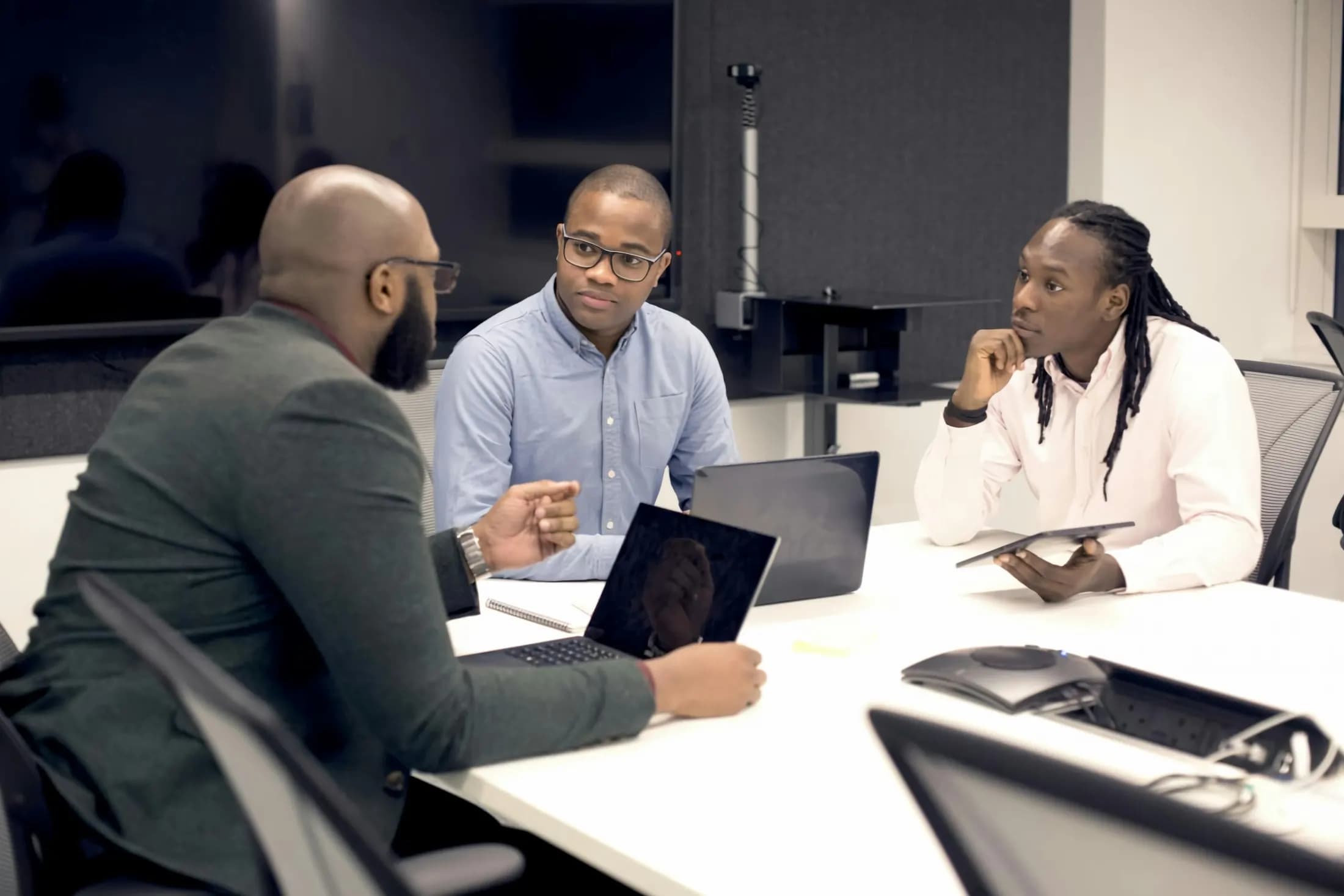 A team meeting around a table in a modern office [seed]